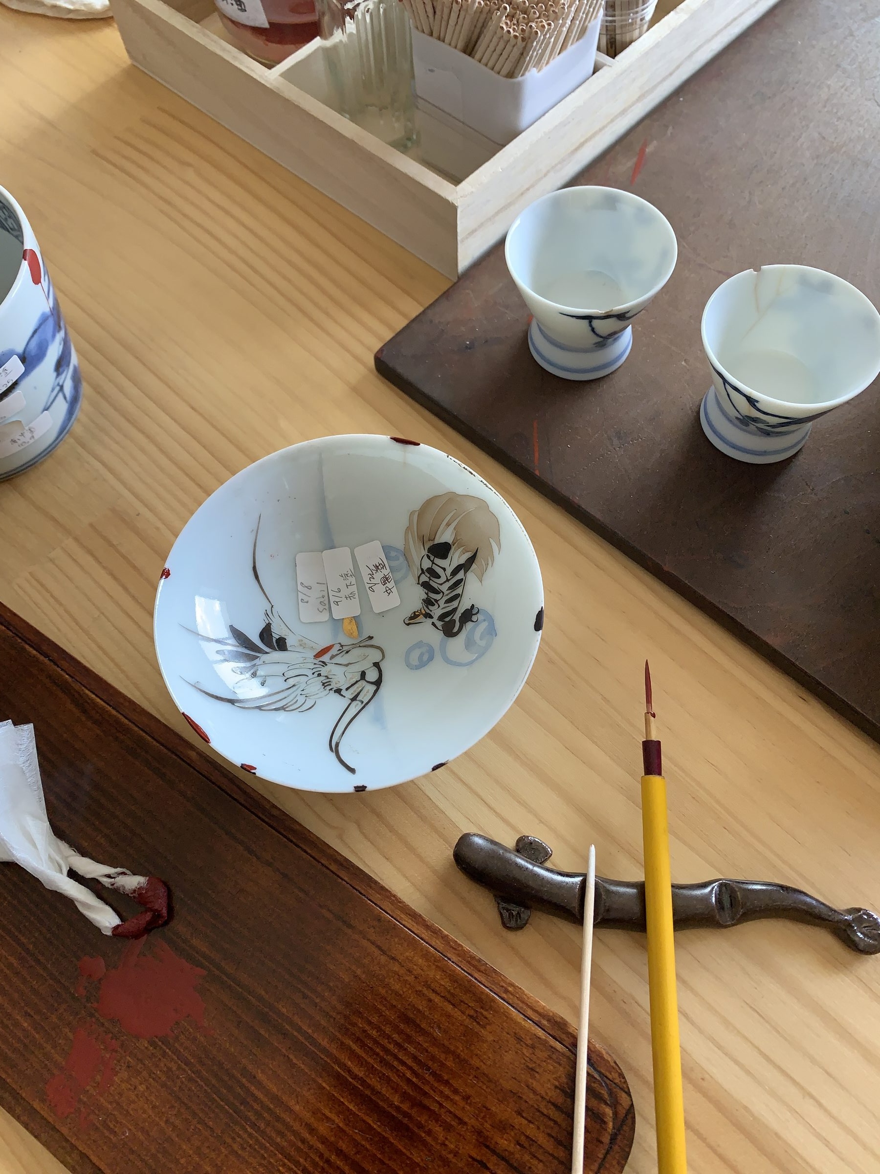Kintsugi crane bowl with brushes and tools in Daigo workshop studio
